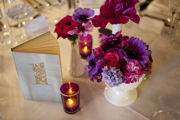 reception table top decorations, candles, flowers, books- wedding photo by top Canadian wedding photographer Rebecca Wood